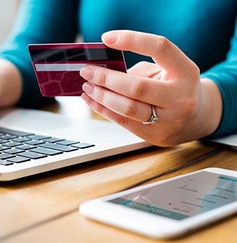 Photo of a hand holding a credit card